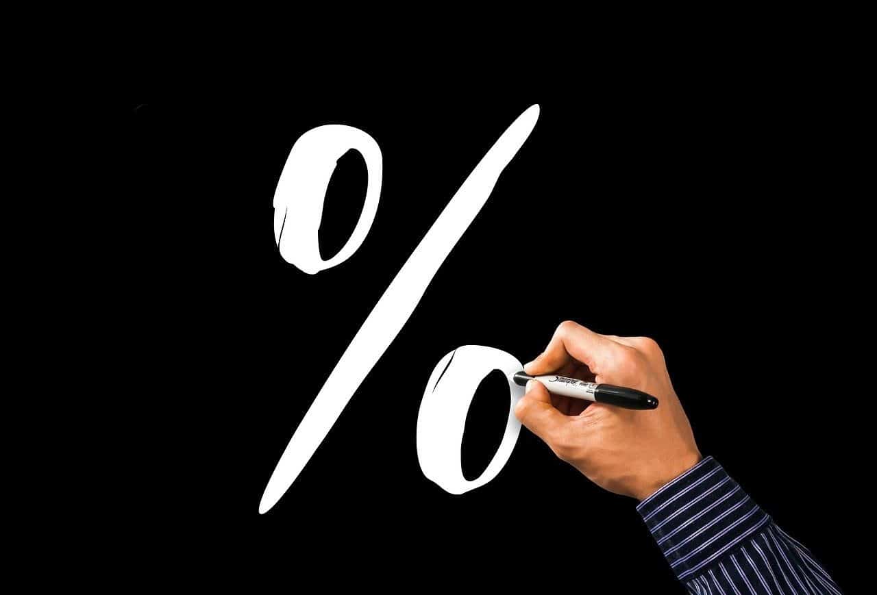 Man drawing blank percentage sign on black background