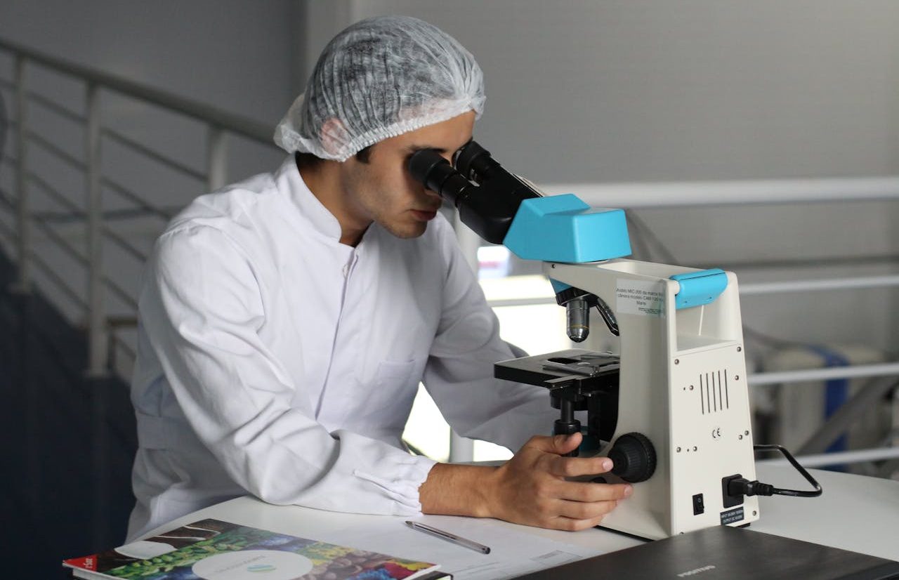 Scientist looking through microscope