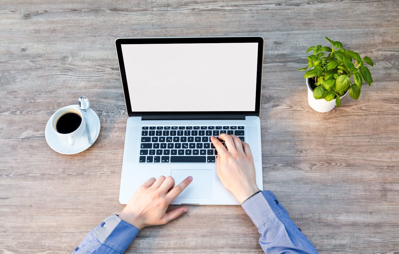 Person typing on his laptop