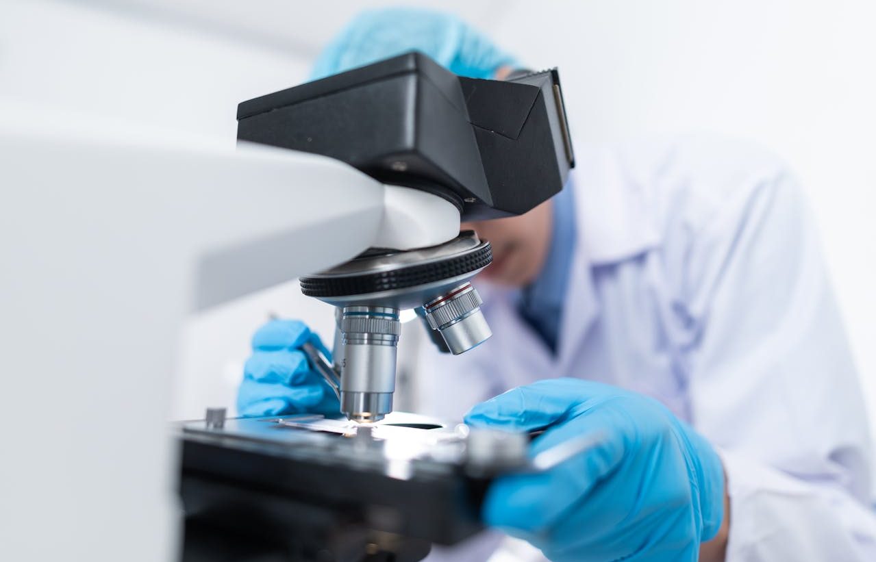 Scientist looking through the microscope.