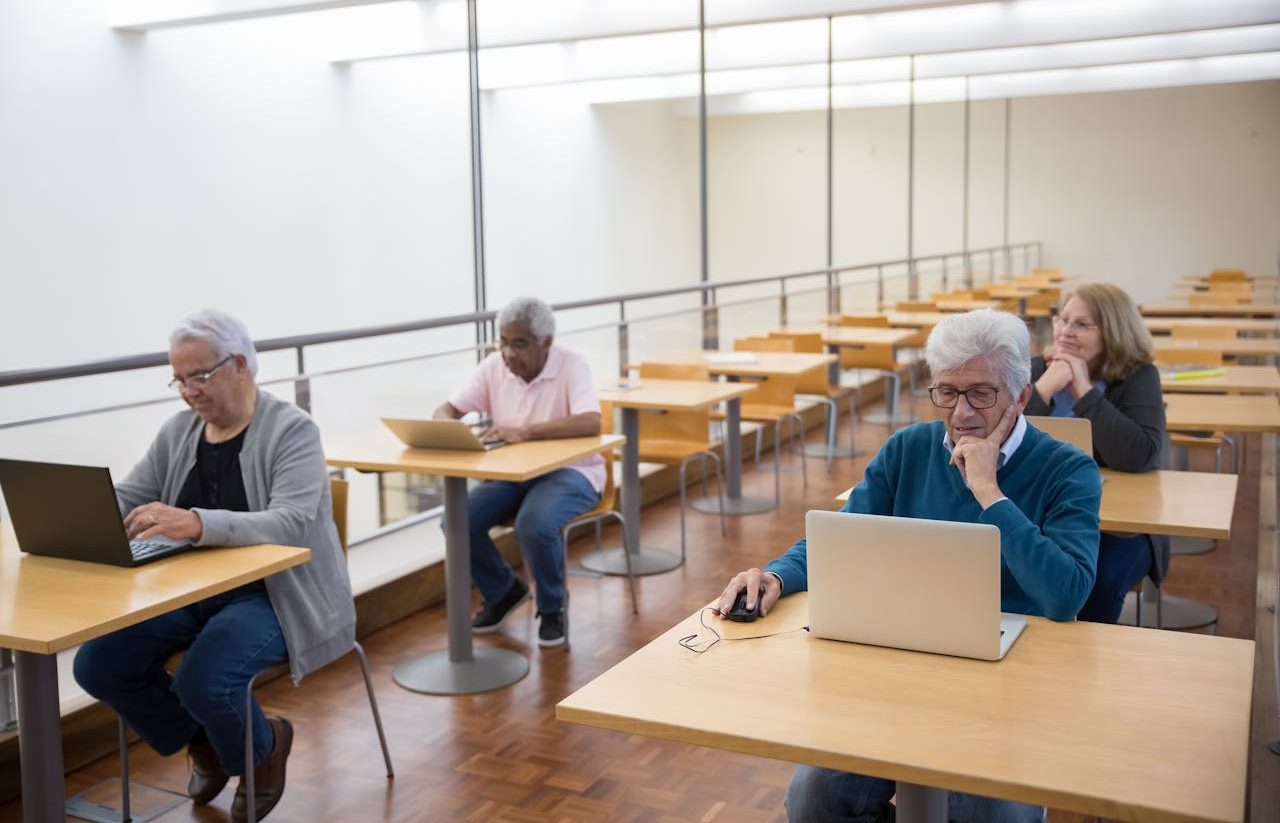 Seniors using computers in school classroom