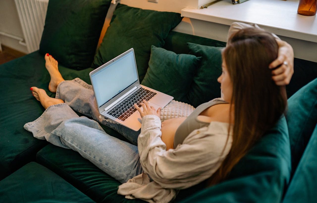 Pregnant woman working with her computer