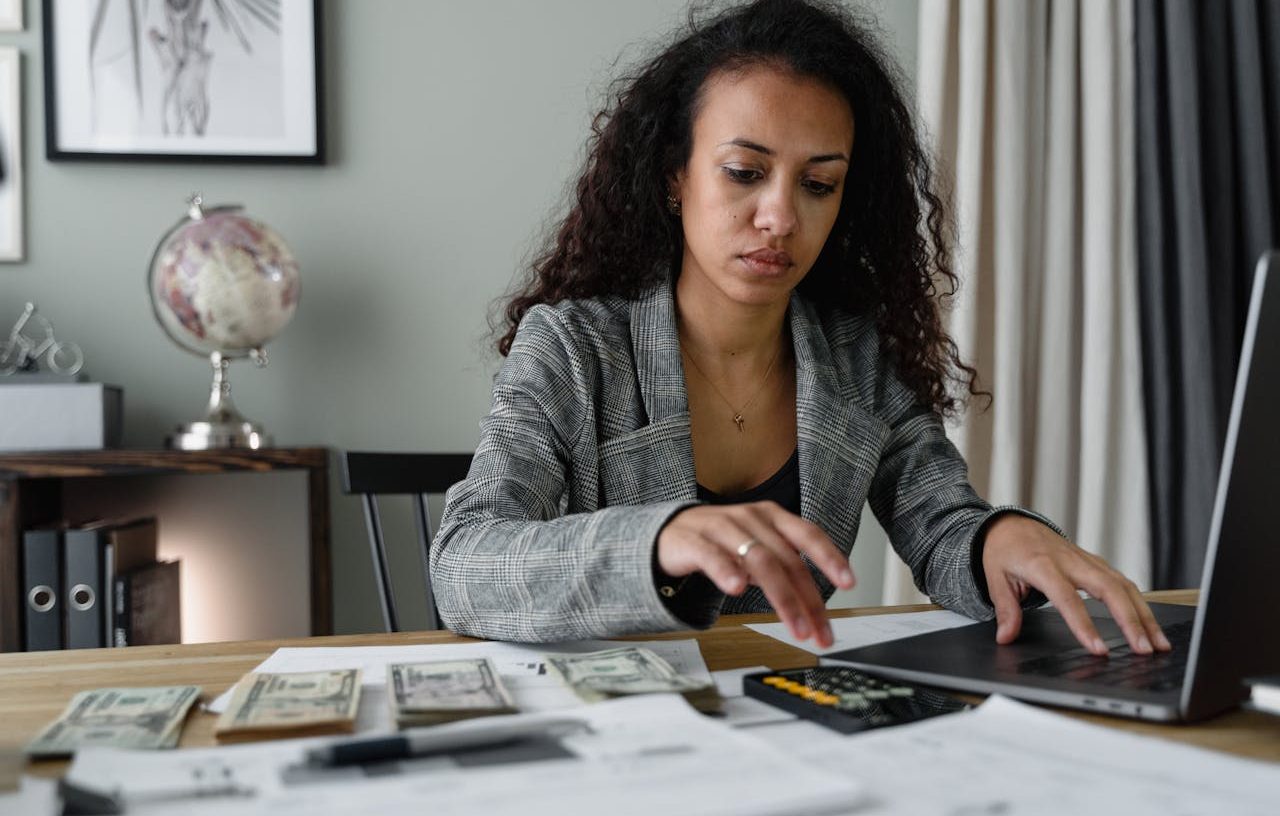 Woman working at her desk with her laptop and calculator