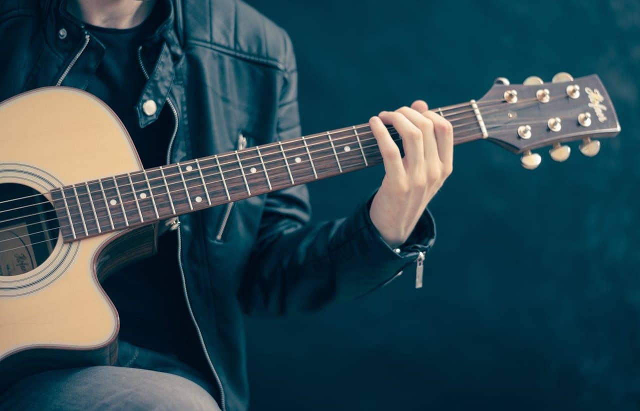 Young person playing guitar.