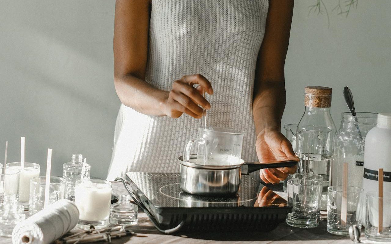 Woman performing experiment with beaker on a hot plate.