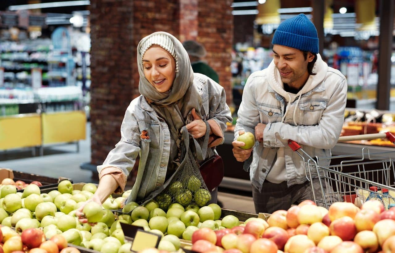 Woman and man buying fruit in the supermarket