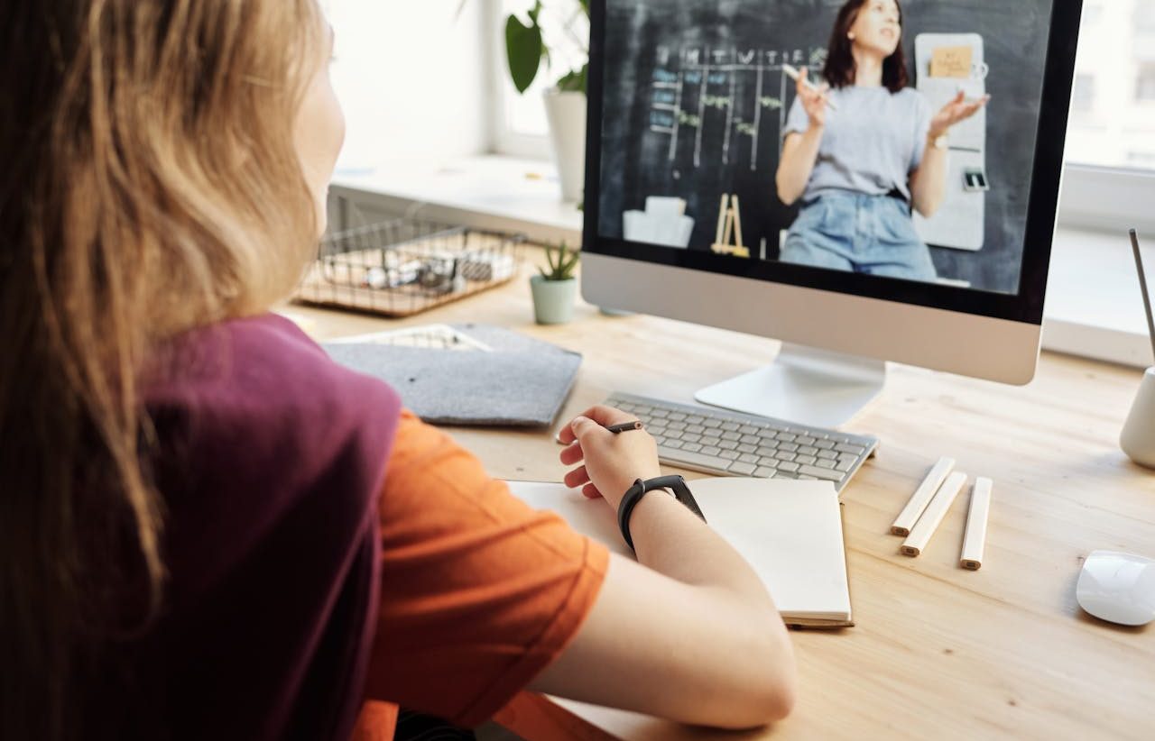 Girl taking virtual classes through a video call