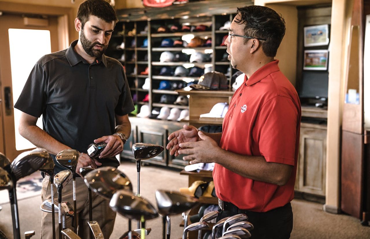 Man buying golf clubs