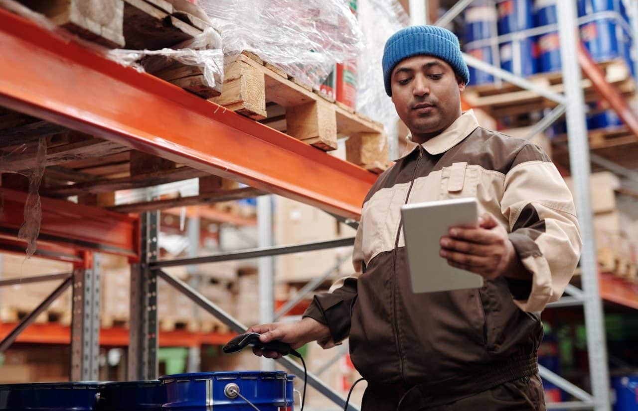 Employee checking inventory in warehouse