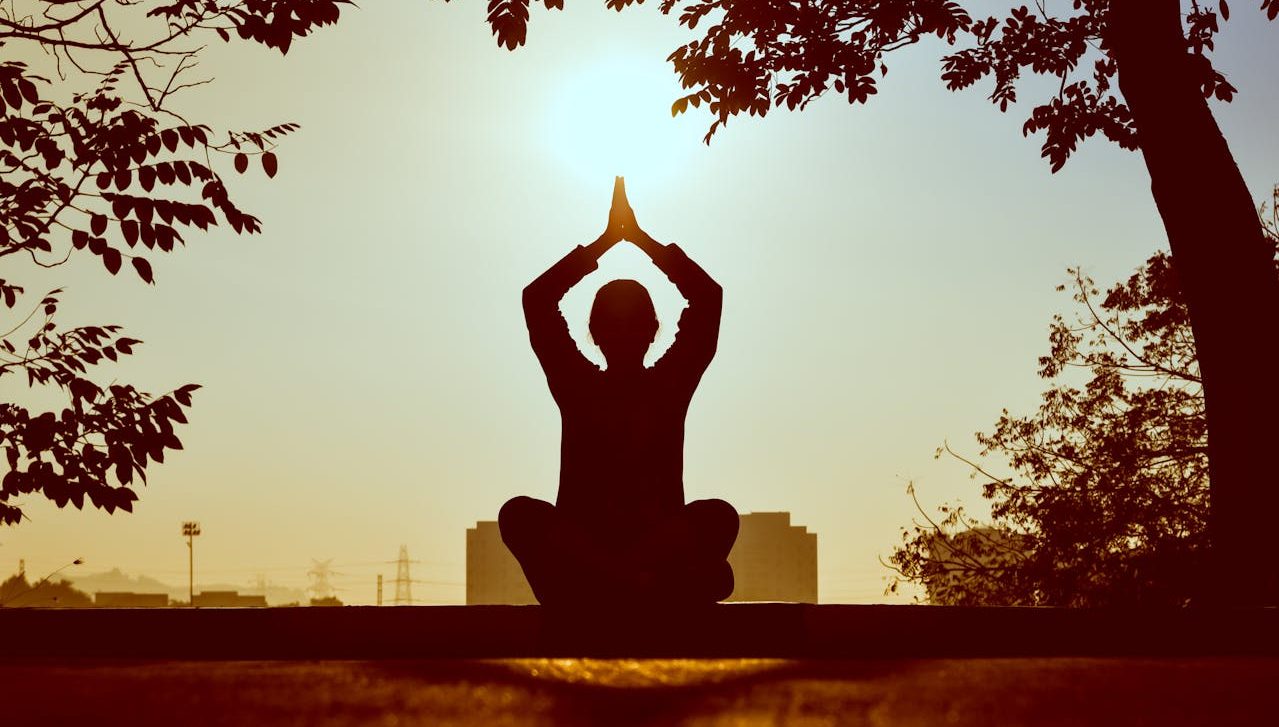 Person meditating outdoors