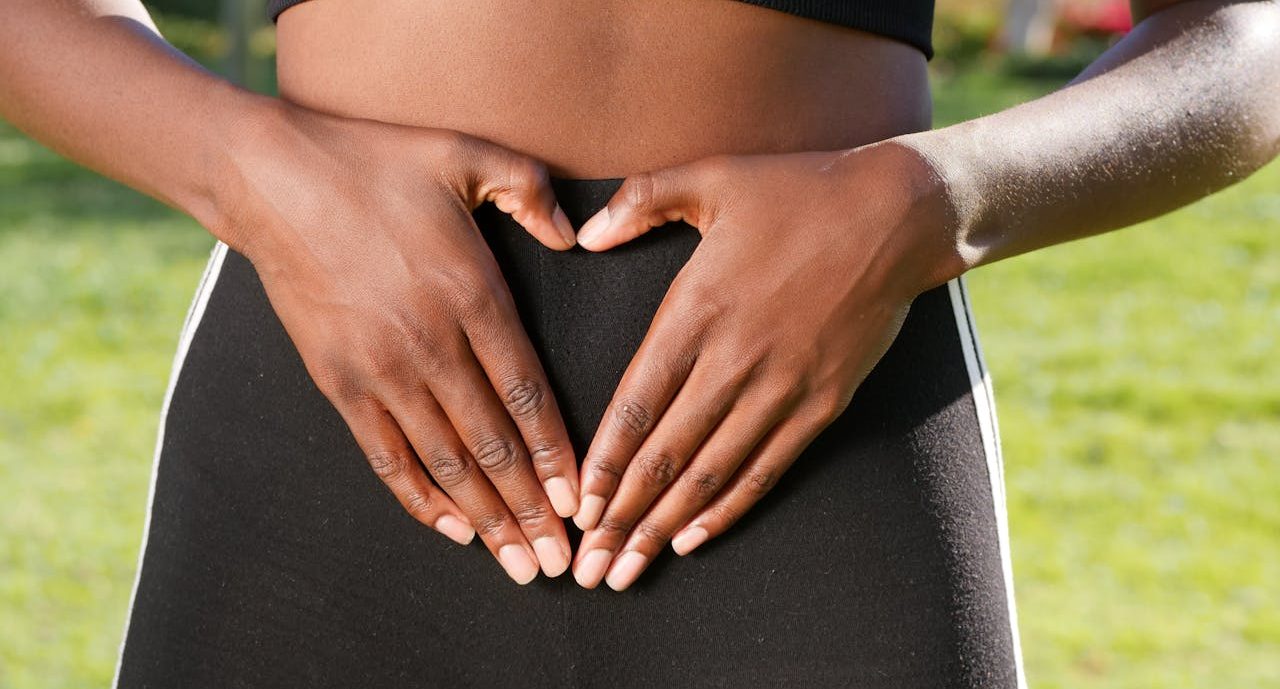 Person with his hands resting on his belly.