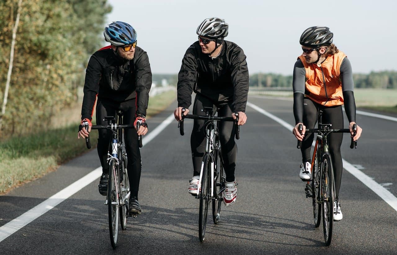 Three cyclists on an urban cycle path